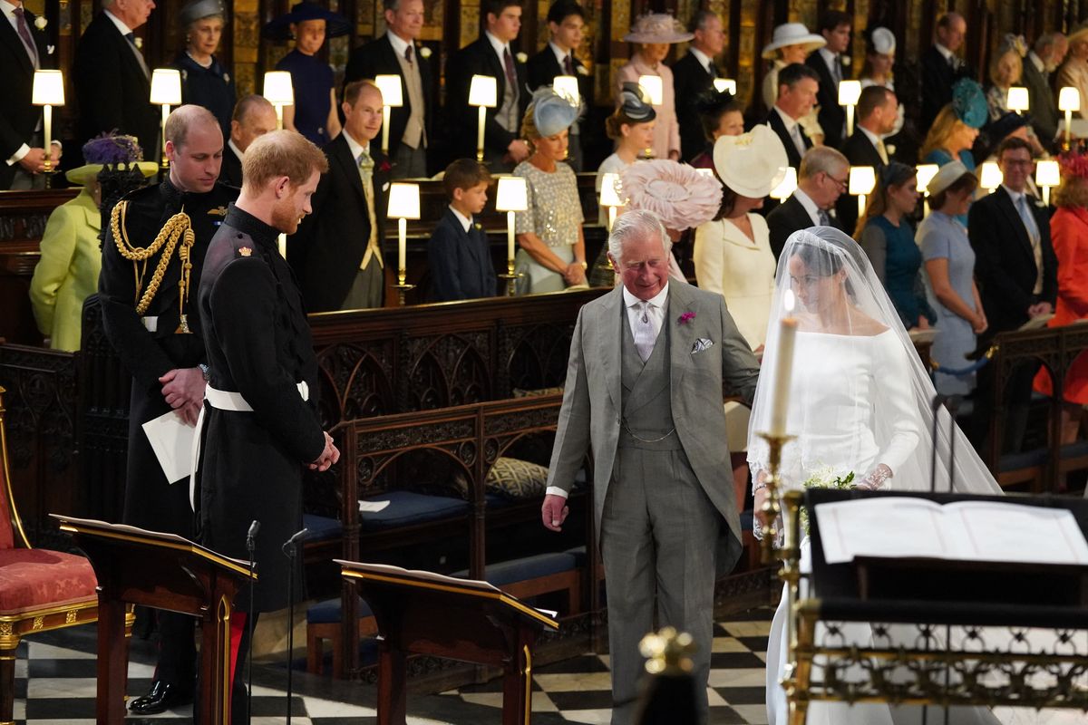 King Charles, then the Prince of Wales, accompanied Meghan Markle down part of the aisle at her wedding to Prince Harry at St. George’s Chapel in Windsor on May 19, 2018, following her father Thomas Markle’s absence from the ceremony.