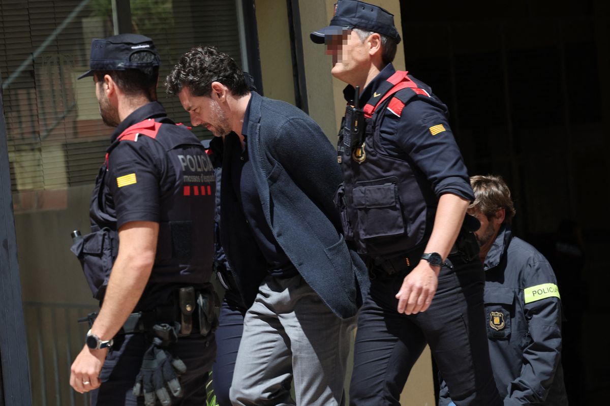 Catalan regional police officers (Mossos d'Esquadra) escort Jonathan Andic, the son of Isak Andic, founder of Spanish fashion brand Mango, as he arrives at a court in Martorell, near Barcelona, following his arrest on May 19, 2026.