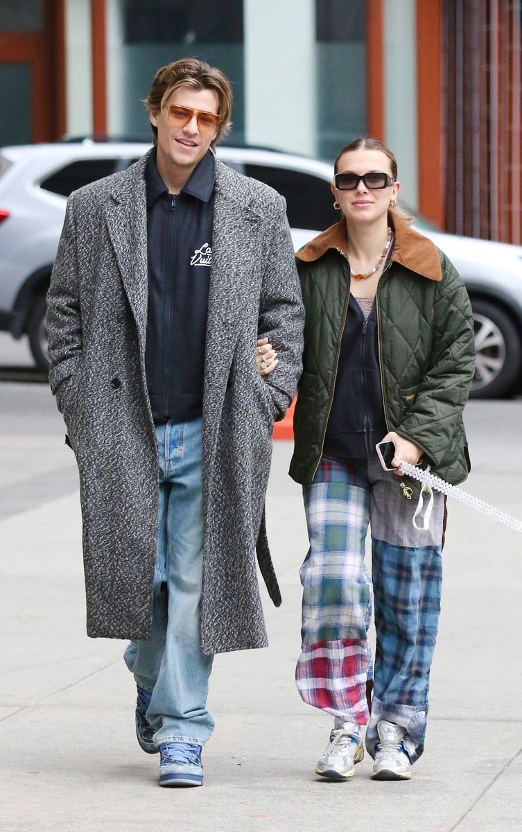 Millie Bobby Brown and her husband Jake Bongiovi share smiles and hold hands during a romantic walk in Downtown Manhattan 