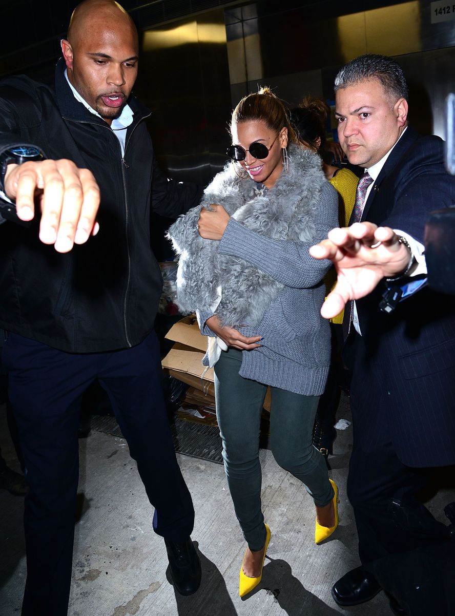 Beyoncé protects her daughter, Blue Ivy Carter, from paparazzi on March 27, 2012.