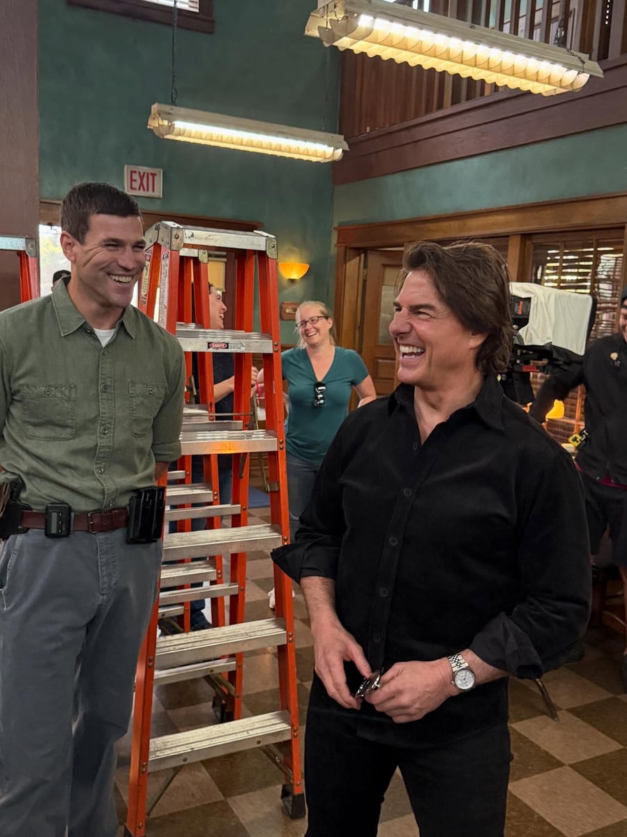 Tom Cruise was spotted laughing and posing for photos with the cast and crew, including Austin Stowell, Tyla Abercrumbie, and Caleb Foote, during his unannounced visit.