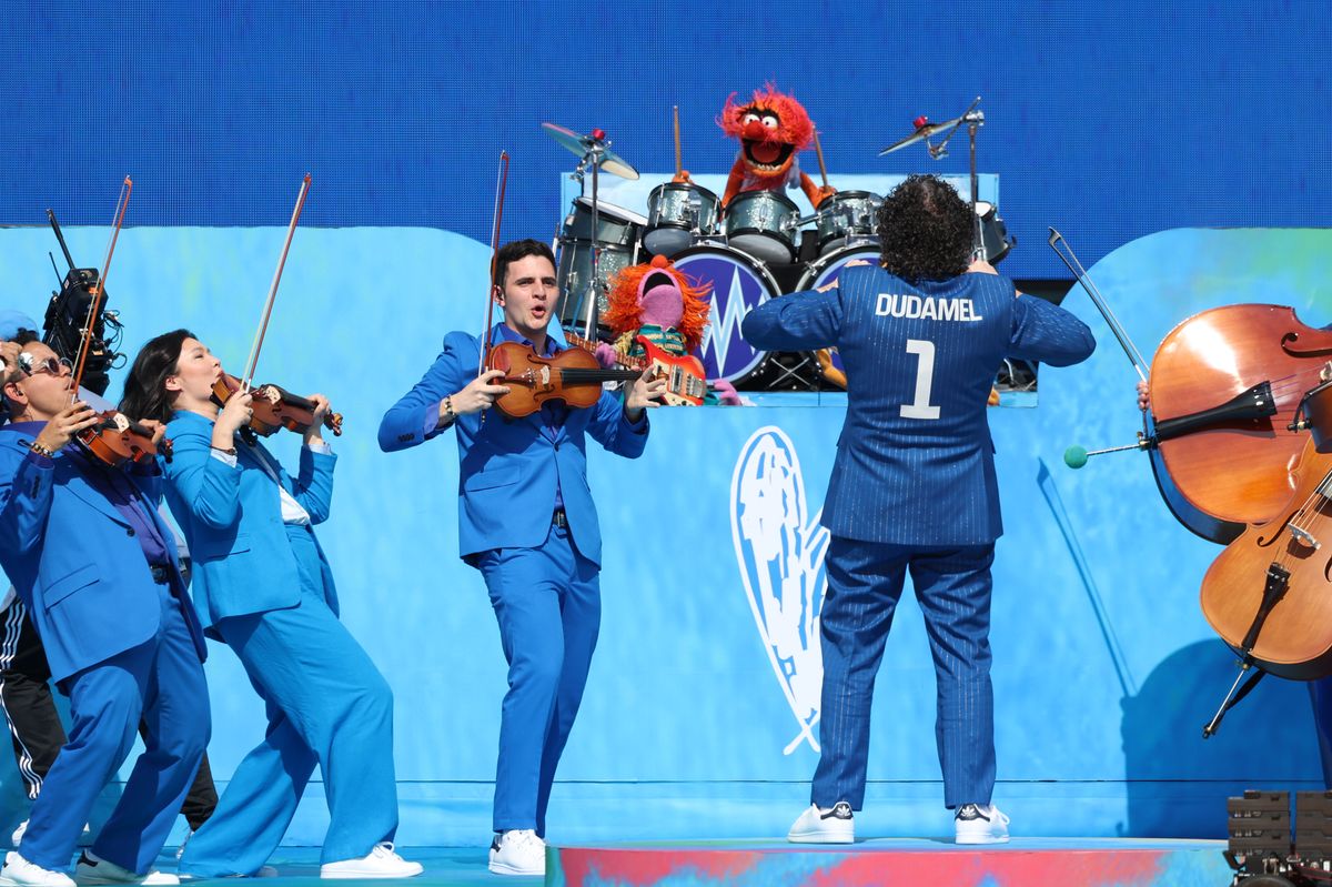 Gustavo Dudamel leads musicians from the New York Philharmonic and the Simón Bolívar Symphony Orchestra on the field.