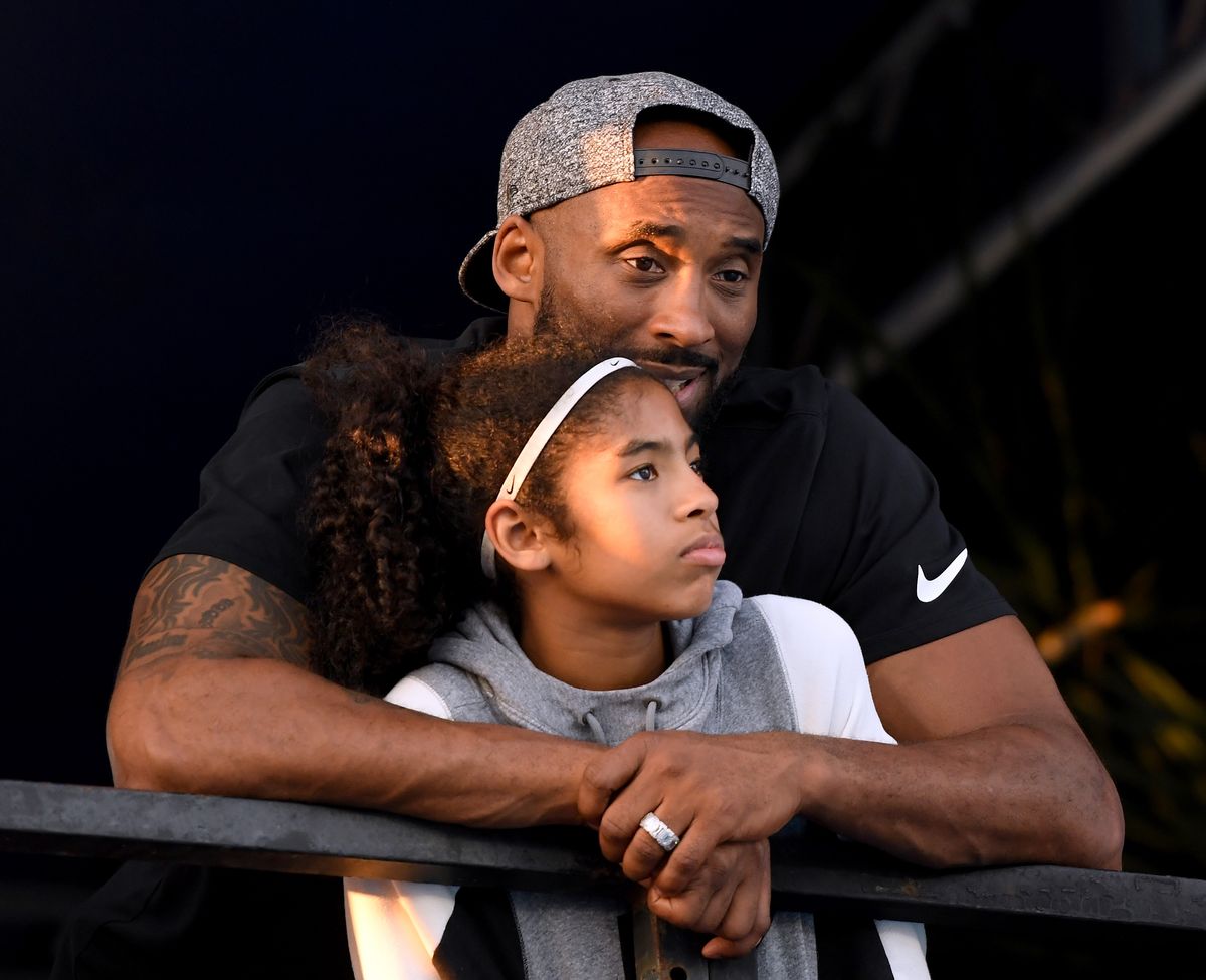 Kobe Bryant and Gianna Bryant watch during day 2 of the Phillips 66 National Swimming Championships at the Woollett Aquatics Center on July 26, 2018, in Irvine, California. 