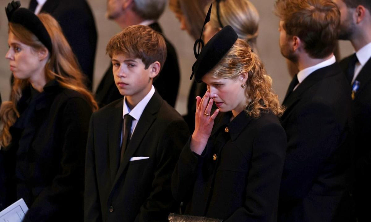 Louise appeared to wipe away a tear during the service