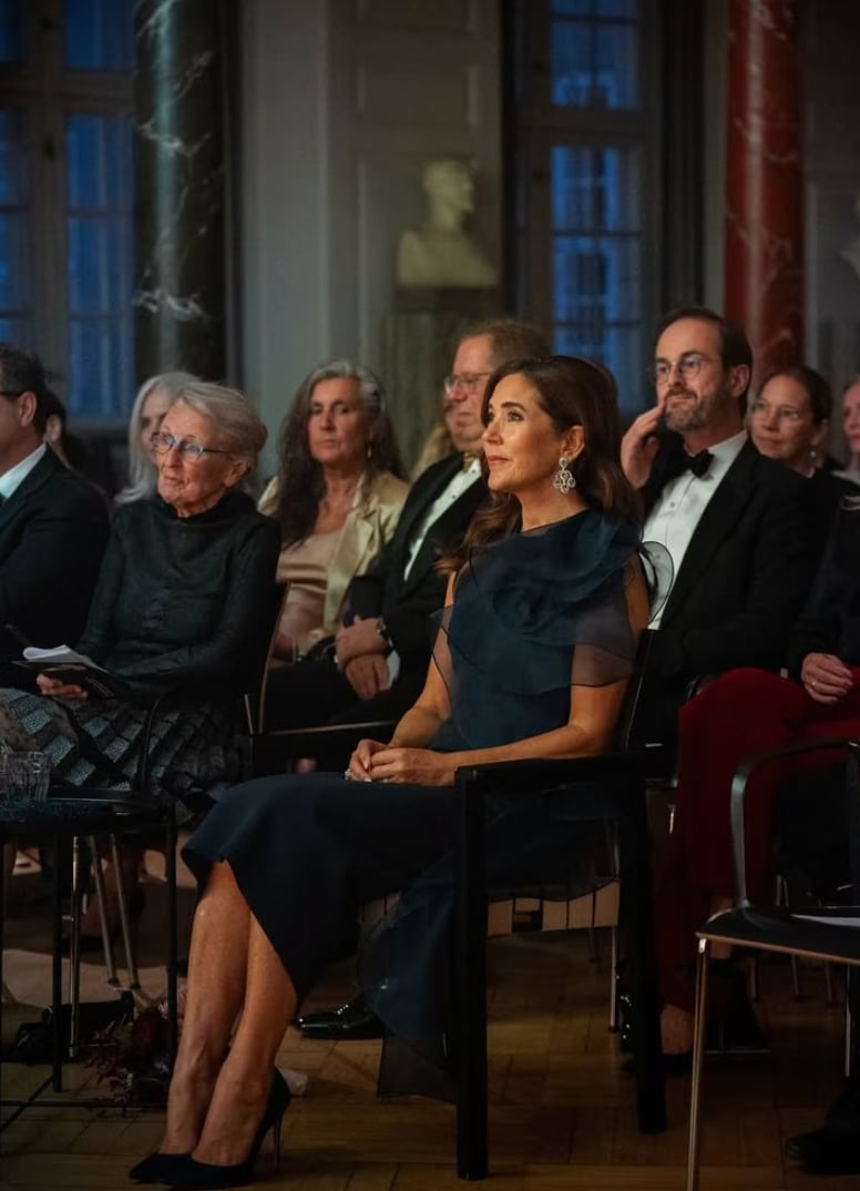 Queen Mary surprised royal watchers in a deep navy cocktail dress that showcased regal elegance and sophistication.