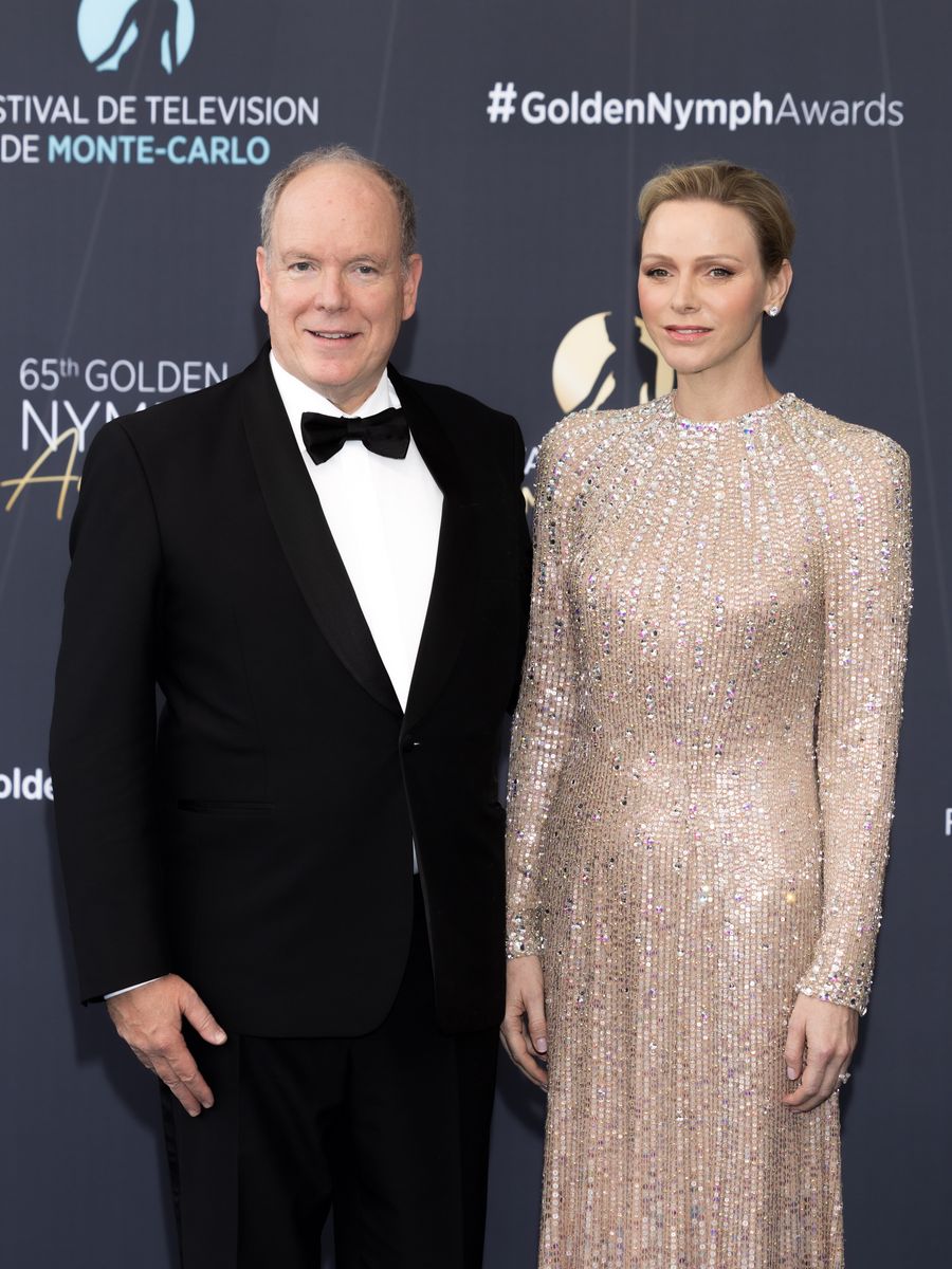 A closer look at Princess Charlene's radiant beauty look, featuring a sleek pixie hairstyle, soft smoky eyes, and timeless diamond stud earrings.