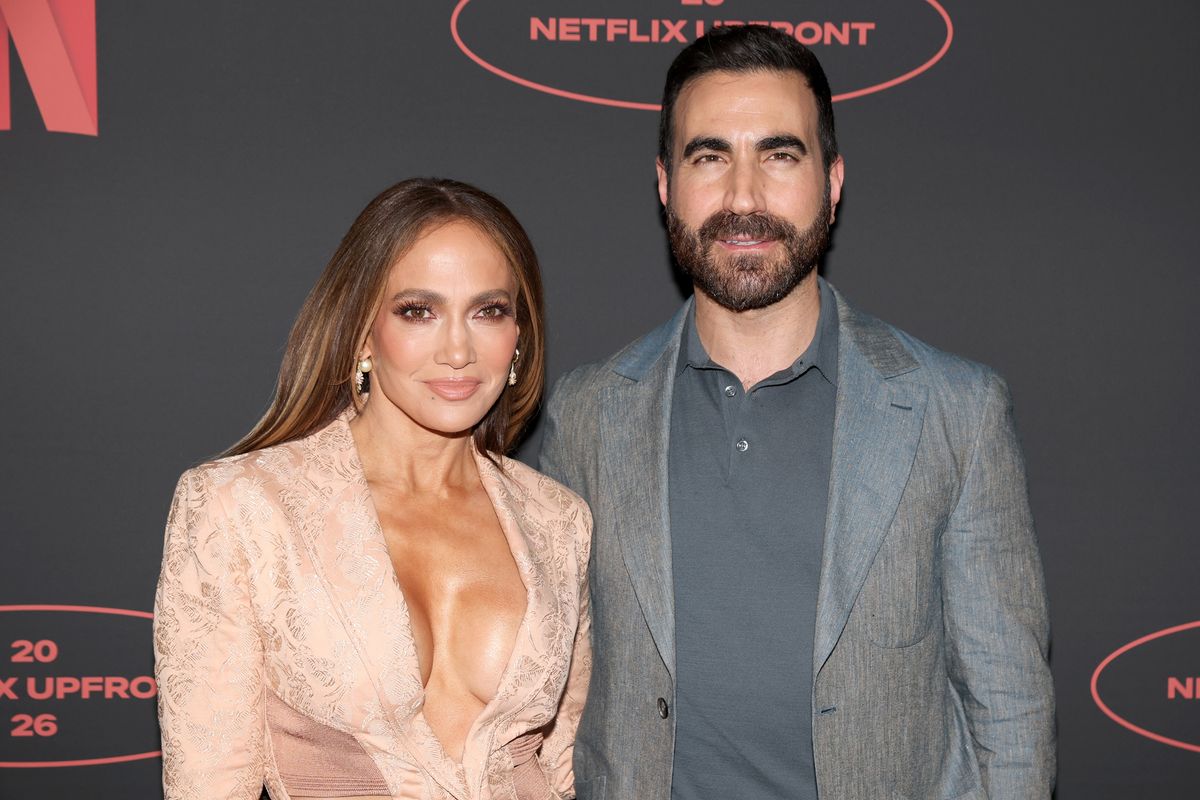 Jennifer Lopez and Brett Goldstein pose together at the 2026 Netflix Upfront at Sunset Pier 94 Studios 