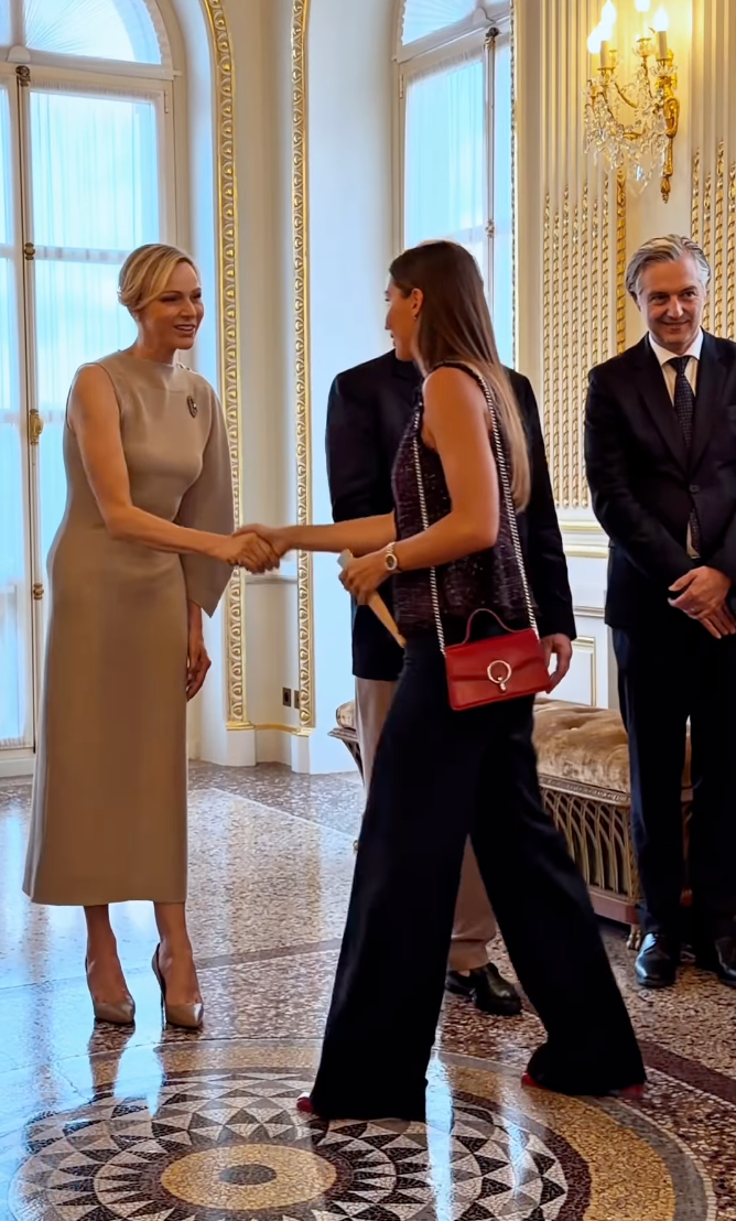 Prince Albert and Princess Charlene appeared in high spirits as they welcomed guests during the humanitarian-focused engagement.