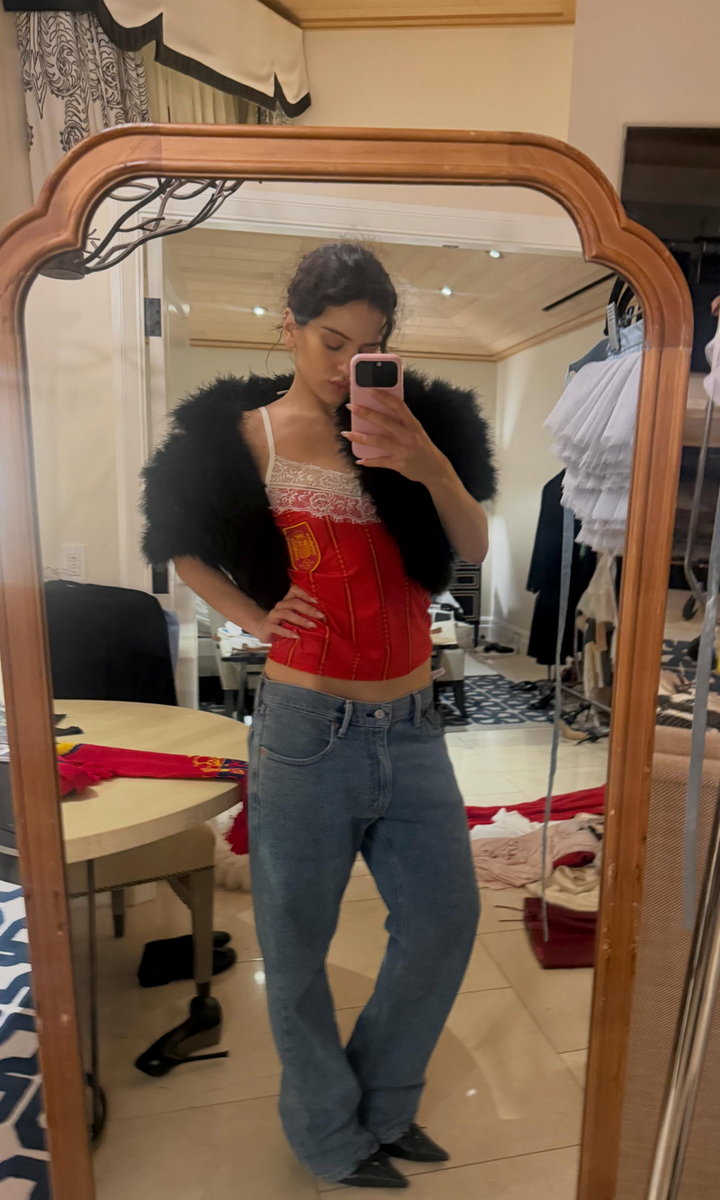 Rosalía paired a Spain football-inspired corset with lace details and relaxed denim during her summer break.