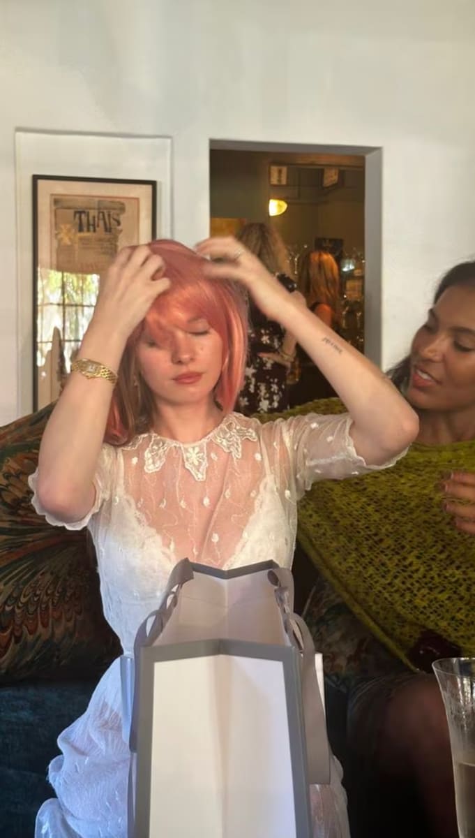 She had fun playing with a pink wig