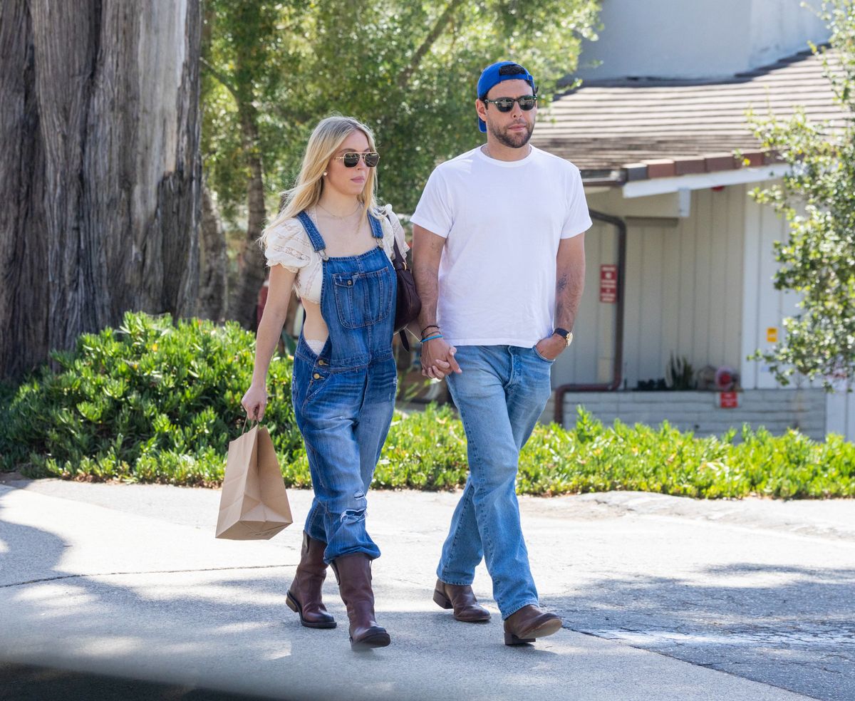 Sydney Sweeney accessorized her denim look with Prada sunglasses and a Miu Miu Aventure nappa leather bag as she joined Scooter Braun for breakfast in Santa Barbara.