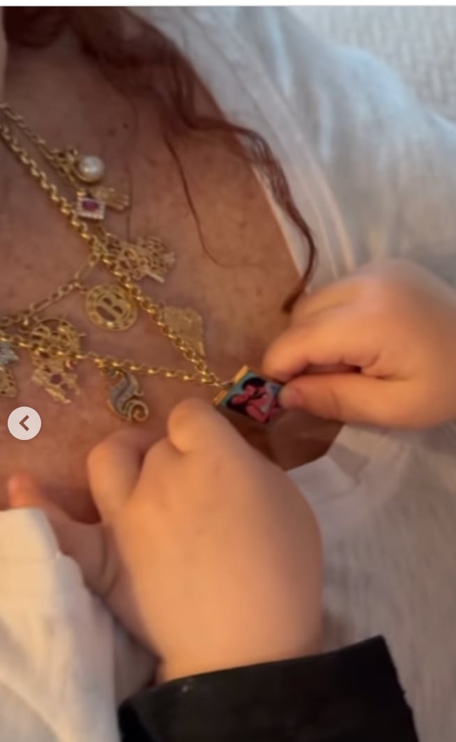 Sandra wears a locket with Selena and Benny's picture inside