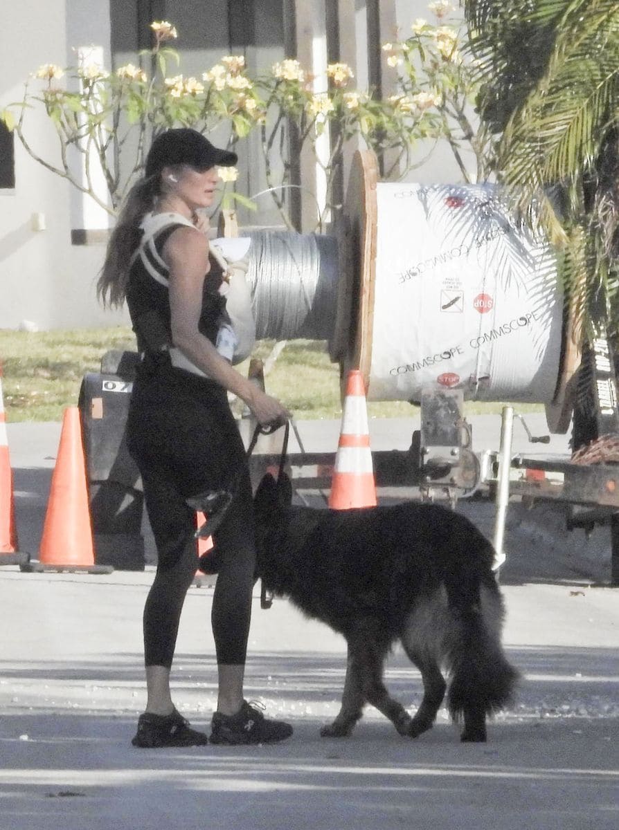 Gisele Bündchen shares a heartwarming moment while strolling through Miami, smiling with joy as she carries her newborn.