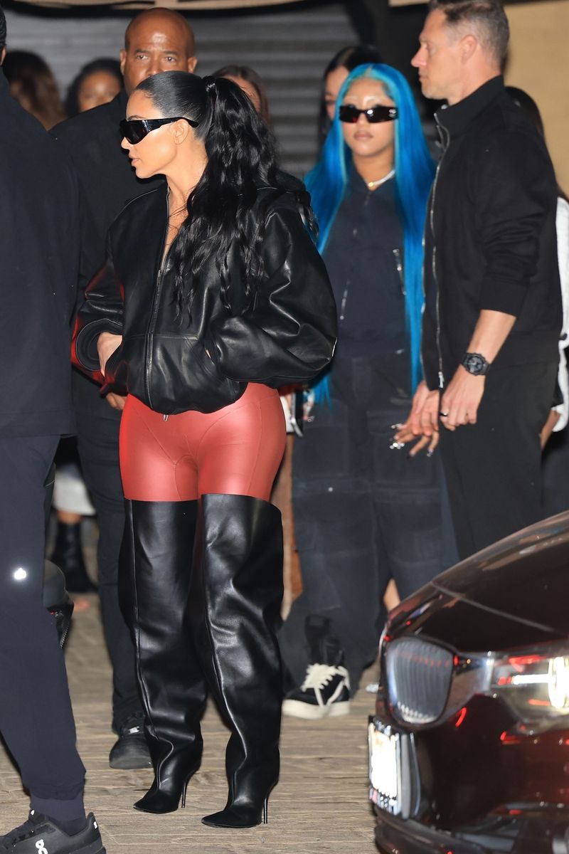 Kim looked stylish in a black leather bomber jacket, black sunglasses, and red pants, while North sported an all-black oversized outfit and super-long, bright blue hair.