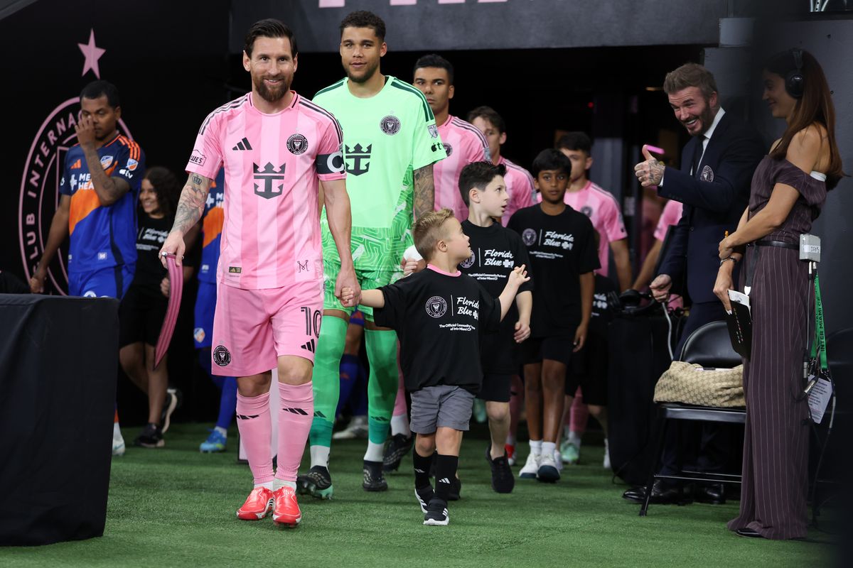 Lionel Messi #10 of Inter Miami CF enters the pitch as Sir David Beckham, of co-owner of Inter Miami, greets a player escort prior to the MLS match