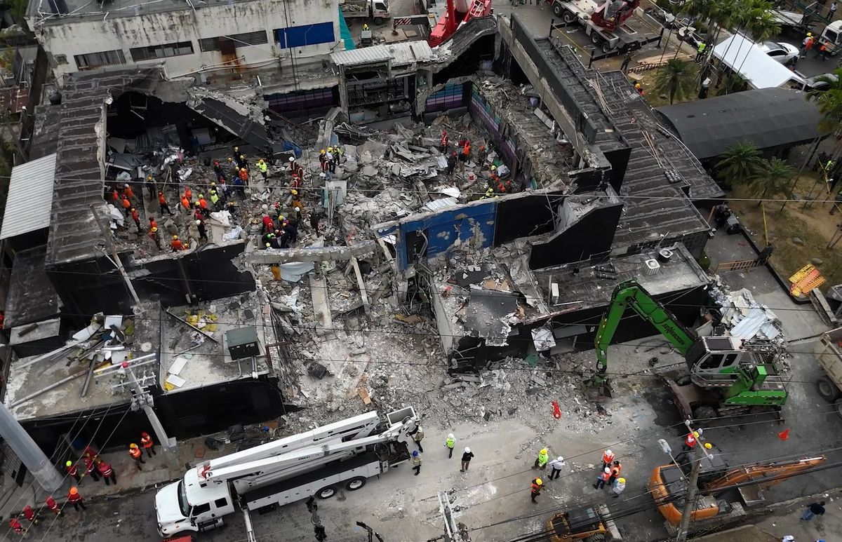 This aerial view shows rescue teams working at the Jet Set nightclub a day after the collapse of its roof in Santo Domingo on April 9, 2025. 