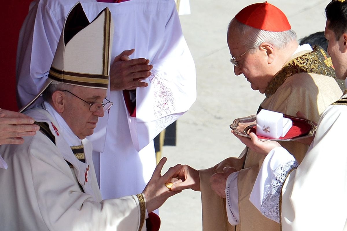 Italian cardinal Angelo Sodano (R) puts the Fisherman's Ring, made of gold-plated silver, on a finger of Pope Francis during his grandiose inauguration mass on March 19, 2013, at the Vatican. 