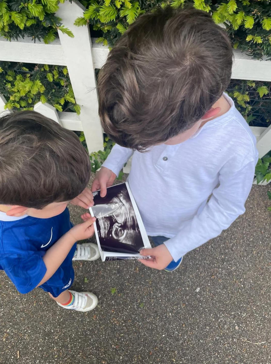 August and Ernest Brooksbank look at an ultrasound photo of their baby sibling after Princess Eugenie announced she was expecting her third child.