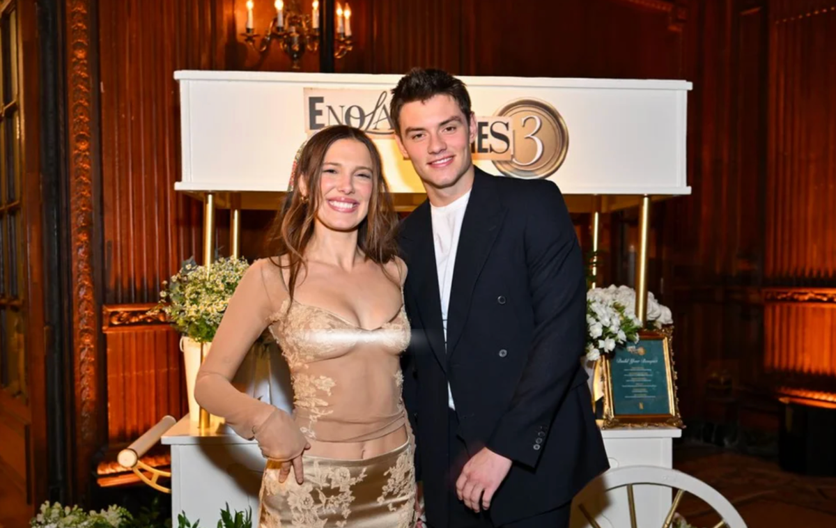 Millie Bobby Brown posed alongside 'Enola Holmes 3' co-star Louis Partridge as the cast celebrated the film's world premiere in New York.