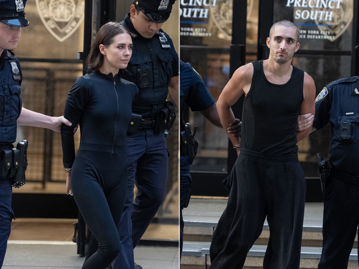 Angela Nikolau, left, and Ivan Beerkus are pictured in police custody leaving the New York Police Department's Midtown South Precinct station house on Wednesday, July 1, 2026, in Manhattan, New York