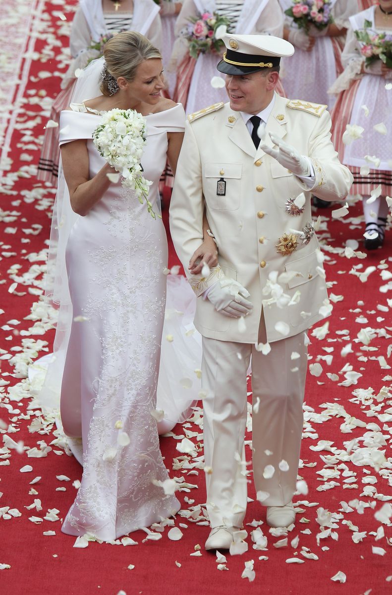 Princess Charlene of Monaco and Prince Albert Of Monaco smile as they leave the palace after the religious ceremony of their Royal Wedding