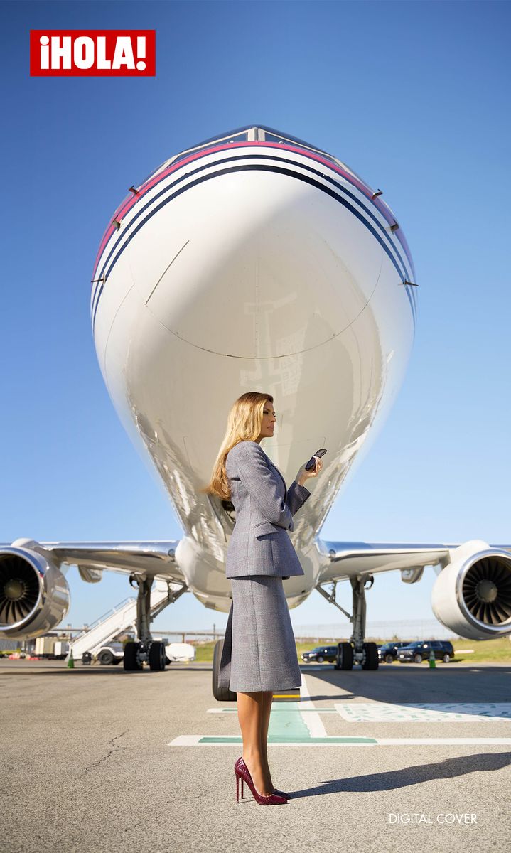 Melania Trump standing elegantly in front of Trump Force One