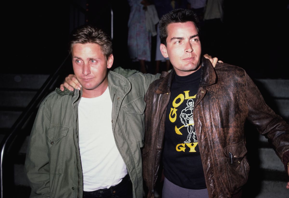 Emilio Estevez, wearing a green M65 field jacket, with his brother Charlie Sheen, wearing a Type A-2 leather flight jacket.