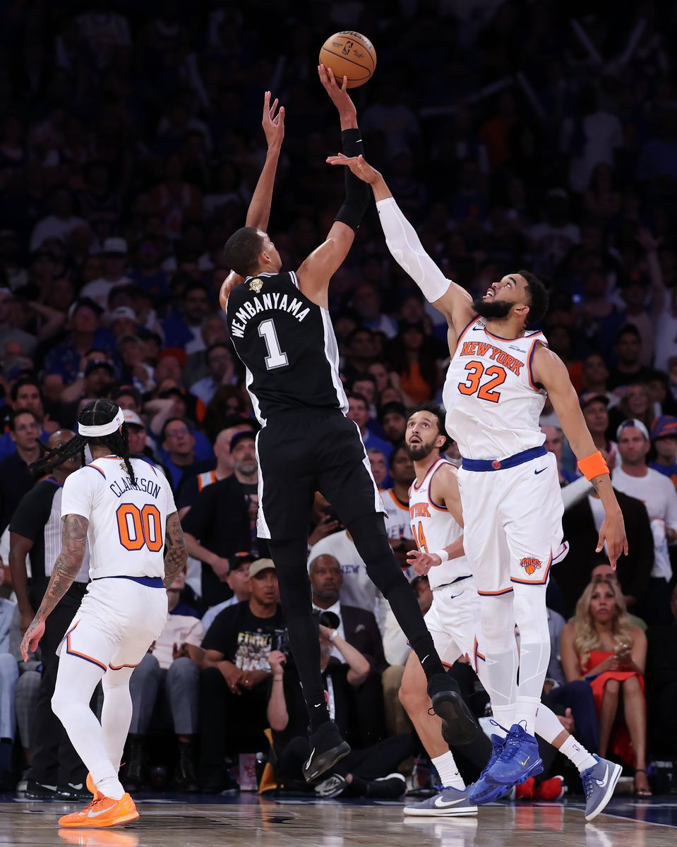 Victor Wembanyama #1 of the San Antonio Spurs shoots the ball against Karl-Anthony Towns #32 of the New York Knicks.