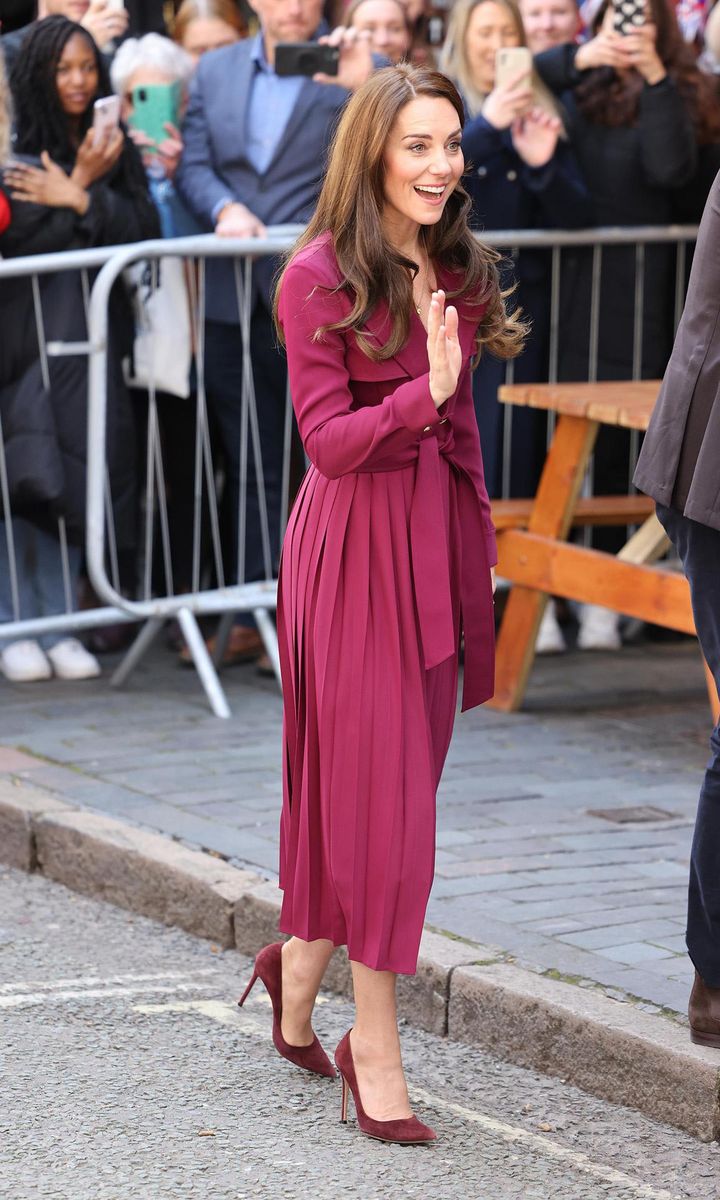 Catherine looked radiant on April 20 wearing a merlot-colored trench dress from Karen Millen.
