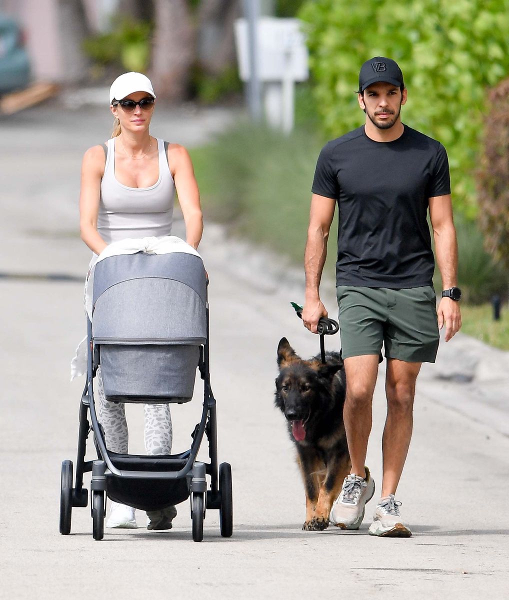 Gisele Bündchen and Joaquim Valente share a kiss as they walk their newborn baby boy