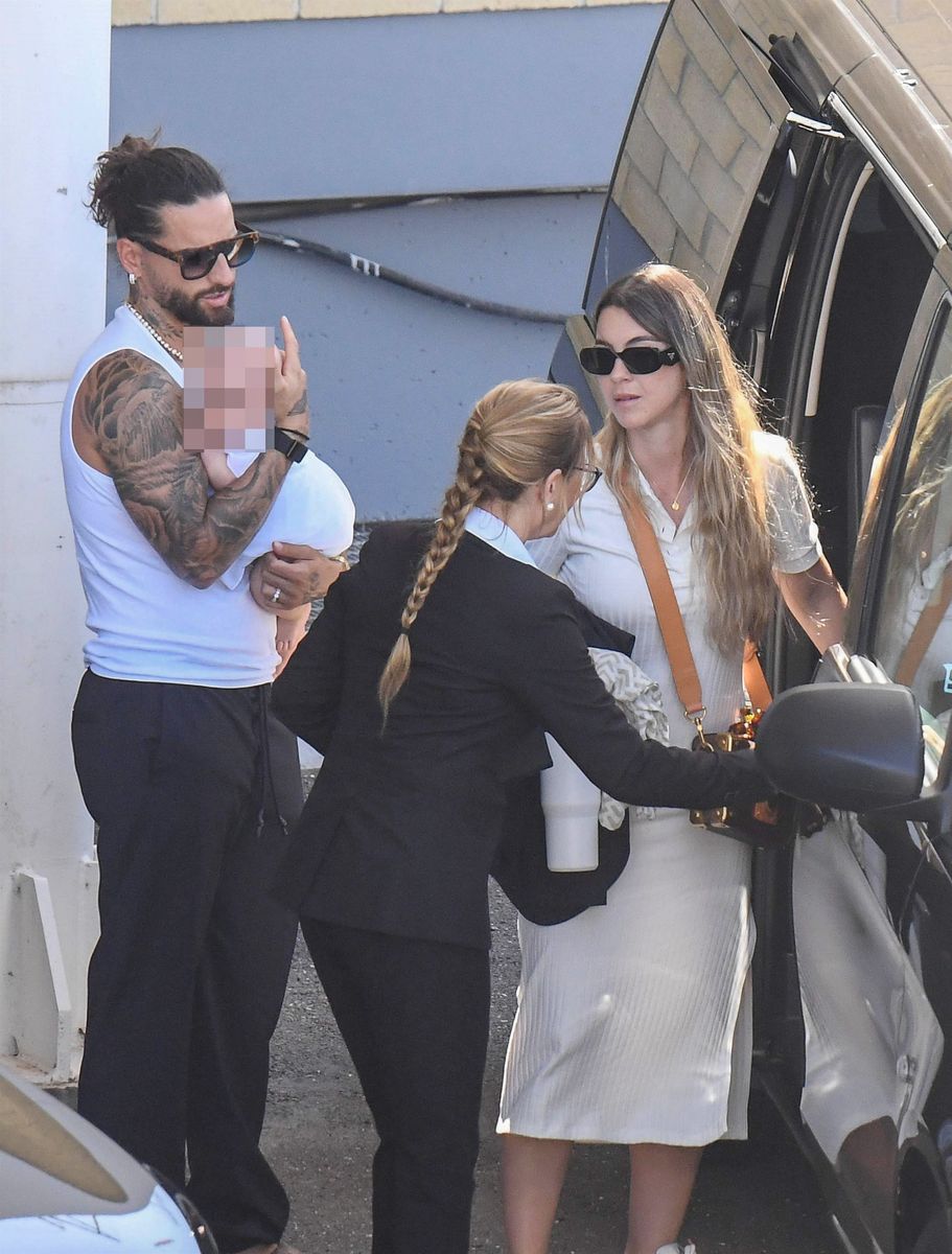 The Colombian rapper and singer Maluma, with his partner Susana Gomez, cradles his baby, arriving in Cagliari for the Dolce & Gabbana event.