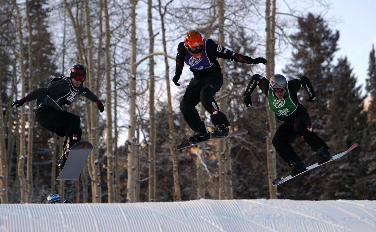 Ueli Kestenholz of Gwatt, Switzerland (C) leads the pack as he takes the gold in the Men's Snowboarder X portion of the VIII Winter X Games on January 26, 2004