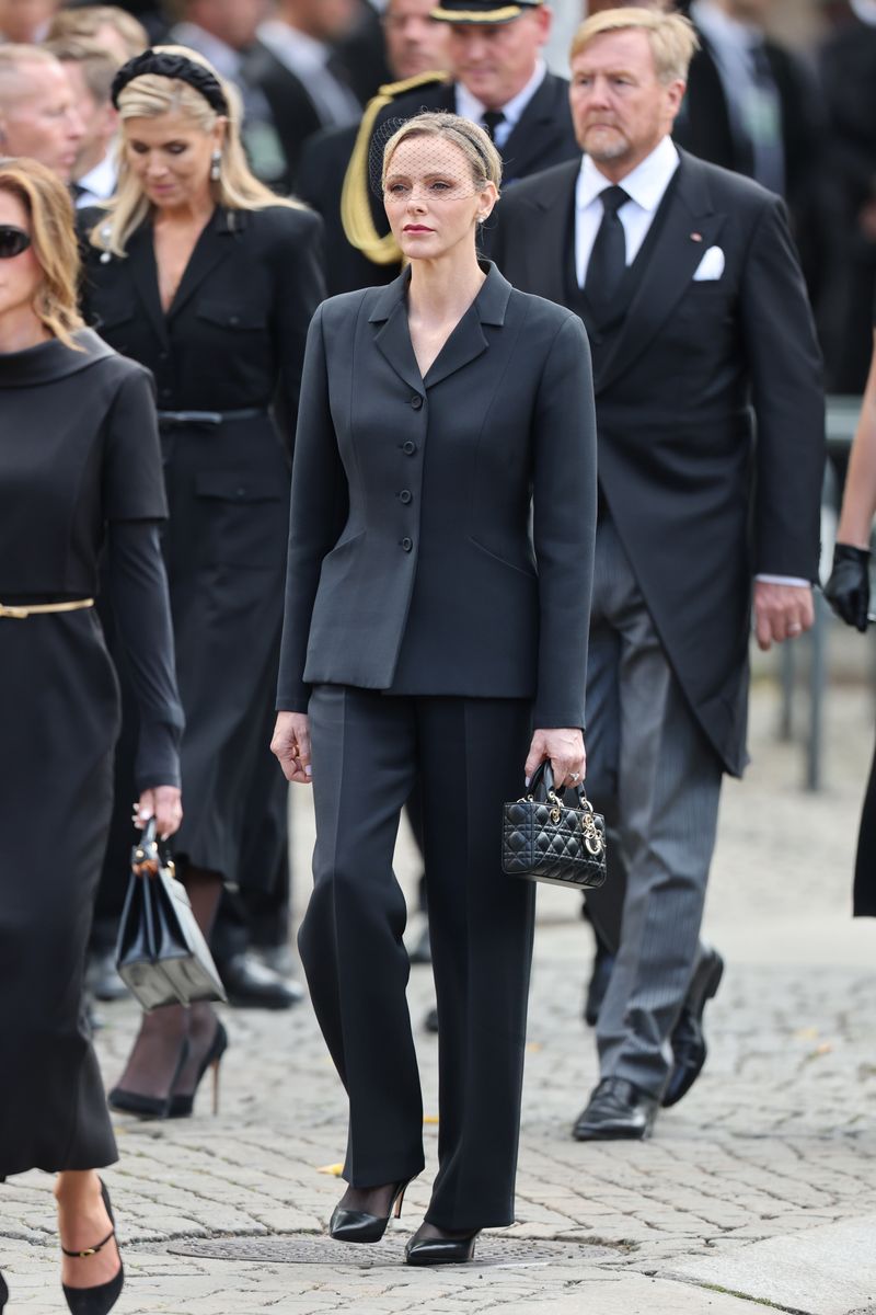 The Princess paired her sharply tailored suit with a traditional black mourning headpiece and delicate net veil.