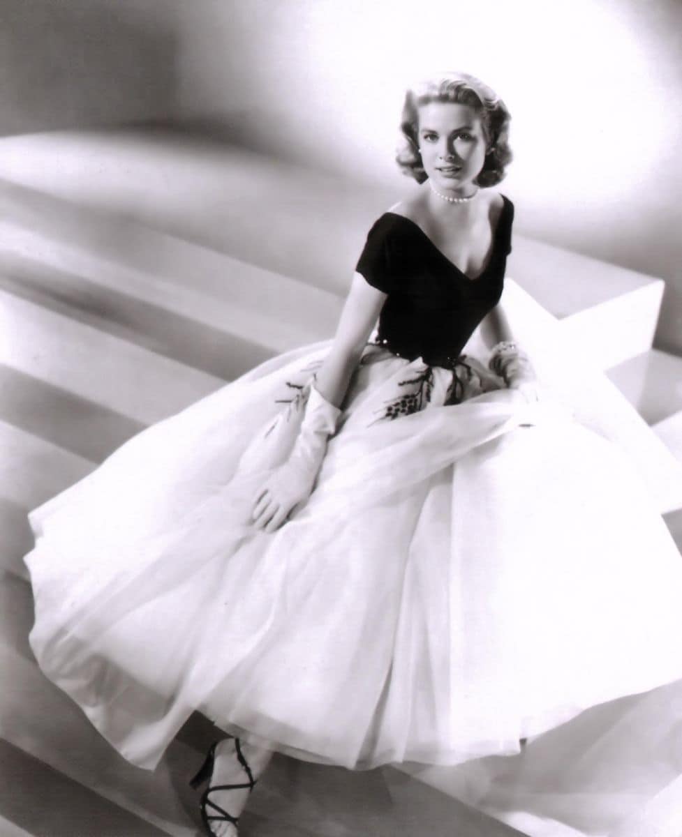 This promotional photograph features Grace Kelly in the 1954 film Rear Window, directed by Alfred Hitchcock. Kelly stars as Lisa Fremont, a fashion model, in a suspenseful thriller about voyeurism and mystery, alongside James Stewart.