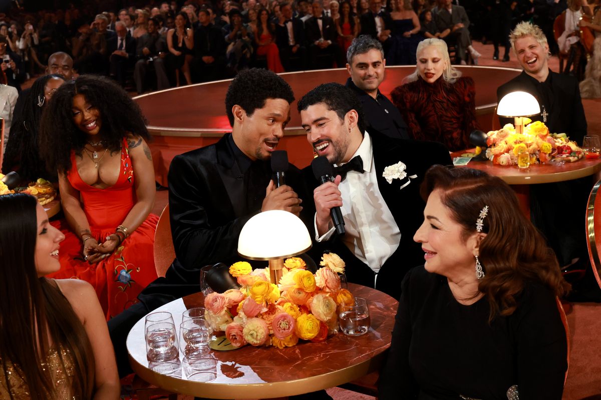 Trevor Noah and Bad Bunny speak onstage during the 68th GRAMMY Awards.