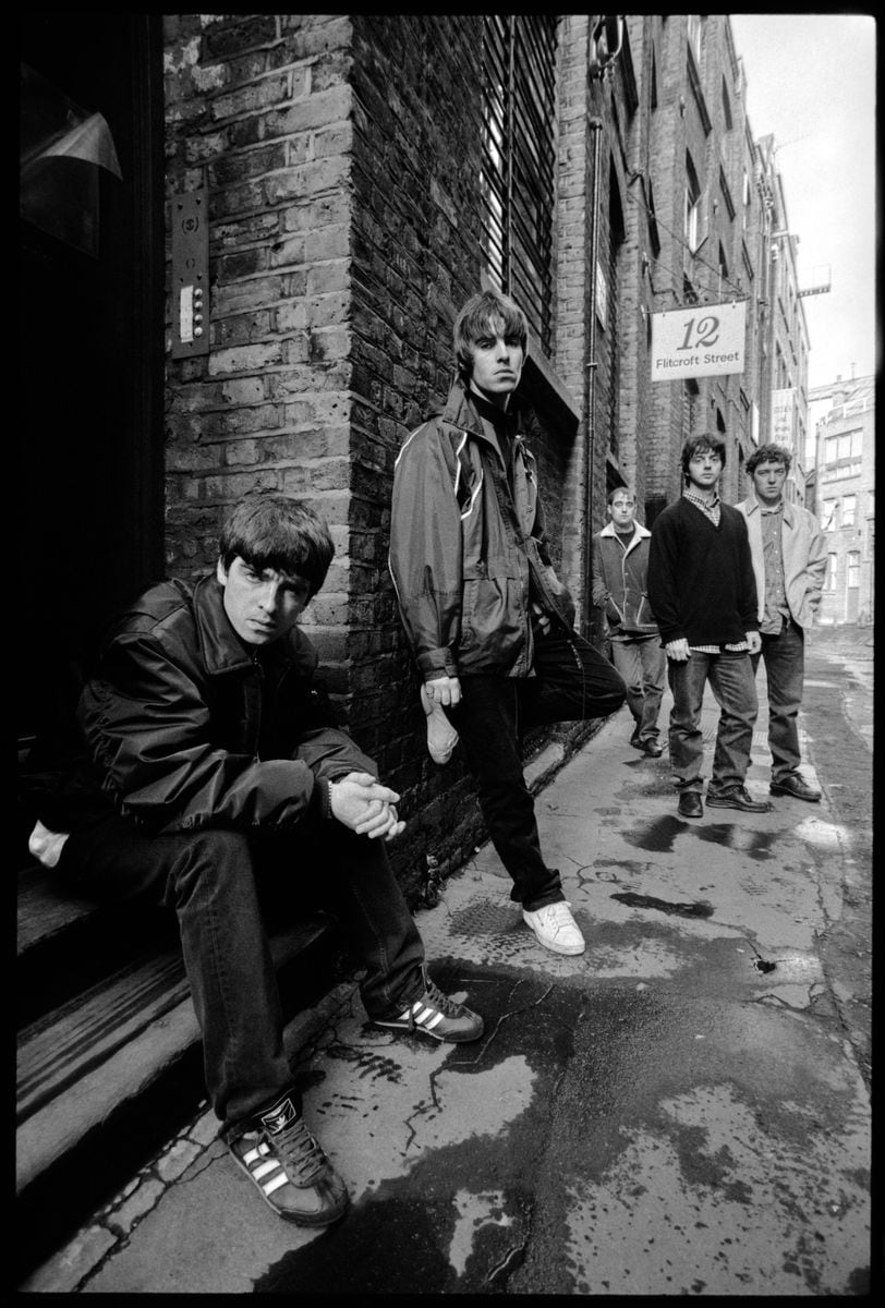 British rock band Oasis (Noel Gallagher, Liam Gallagher, Paul McGuigan, Paul Arthurs, Tony McCarroll) on Flitcroft St, London WC2, 15 March 1994