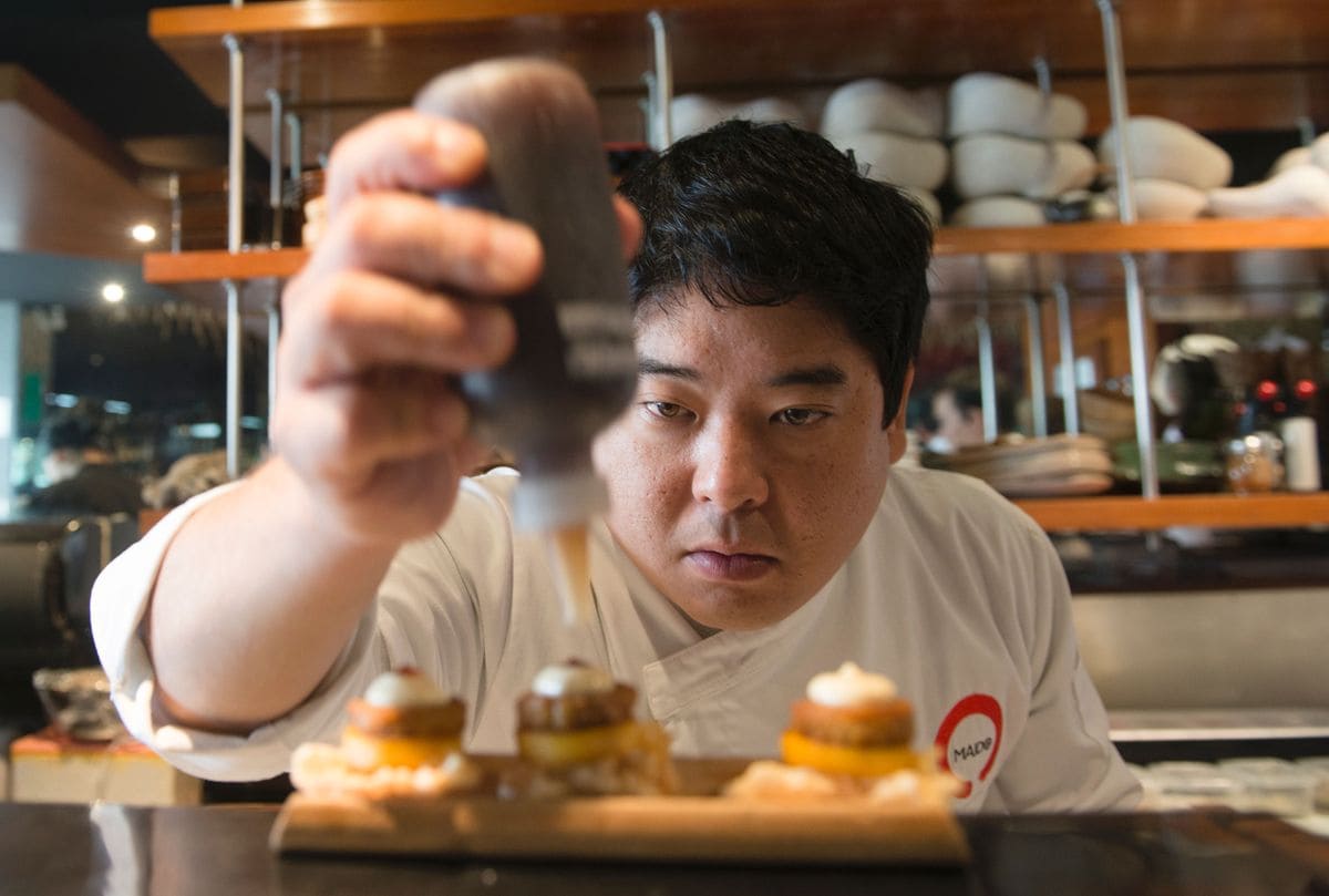 Peruvian Nikkei chef Mitsuharu Tsumura, known as Misho, places the final touches on a dish of his creation at the Maido high-cuisine restaurant in Lima on June 17, 2016.