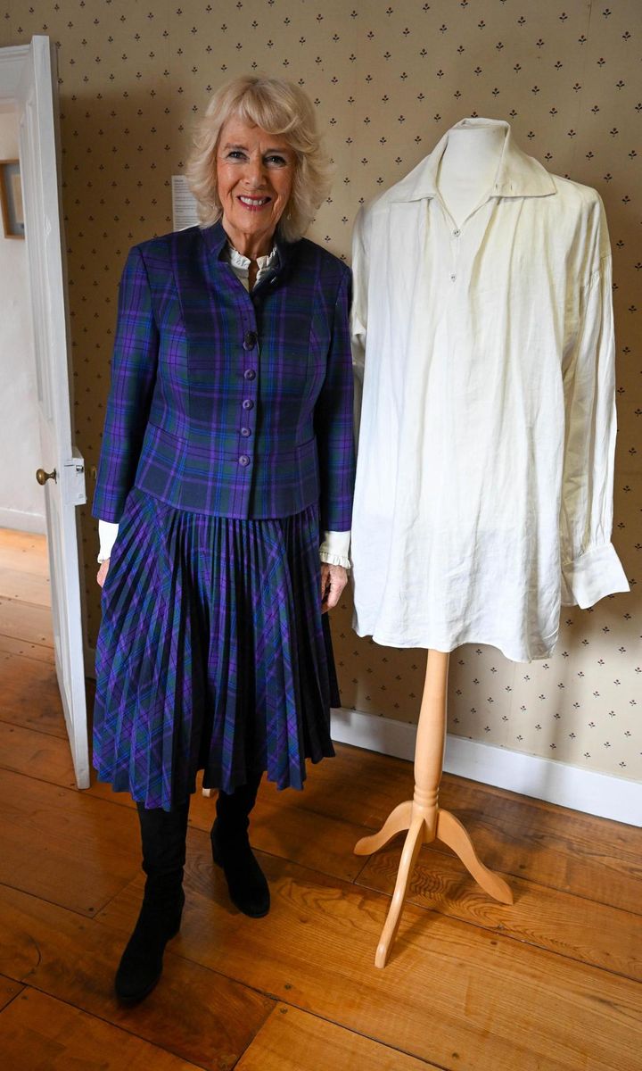 The Queen (pictured with a shirt worn by Colin Firth in Pride and Prejudice) has said that Elizabeth Bennett is a "heroine of mine."