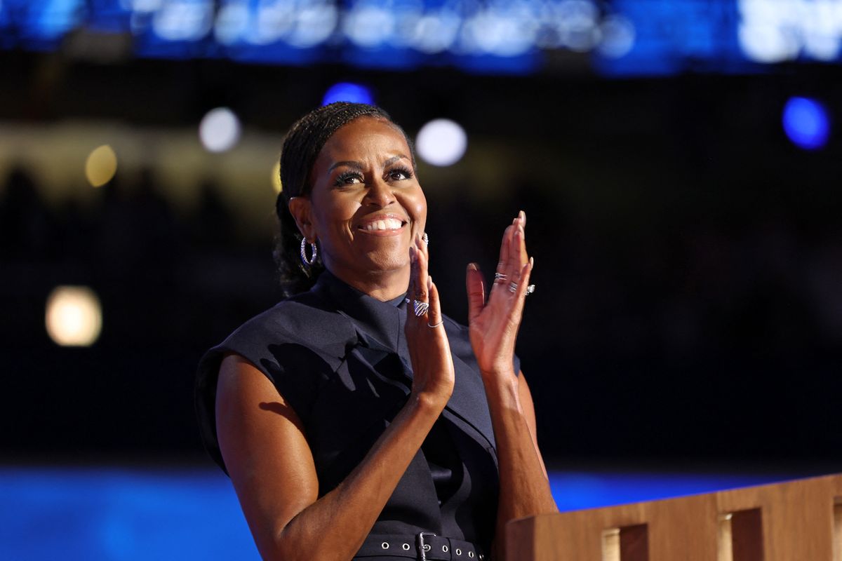 Former US First Lady Michelle Obama applauds as she speaks on the second day of the Democratic National Convention (DNC) at the United Center in Chicago, Illinois, on August 20, 2024. Vice President Kamala Harris will formally accept the party's nomination for president at the DNC which runs from August 19-22 in Chicago. (Photo by CHARLY TRIBALLEAU / AFP) (Photo by CHARLY TRIBALLEAU/AFP via Getty Images)