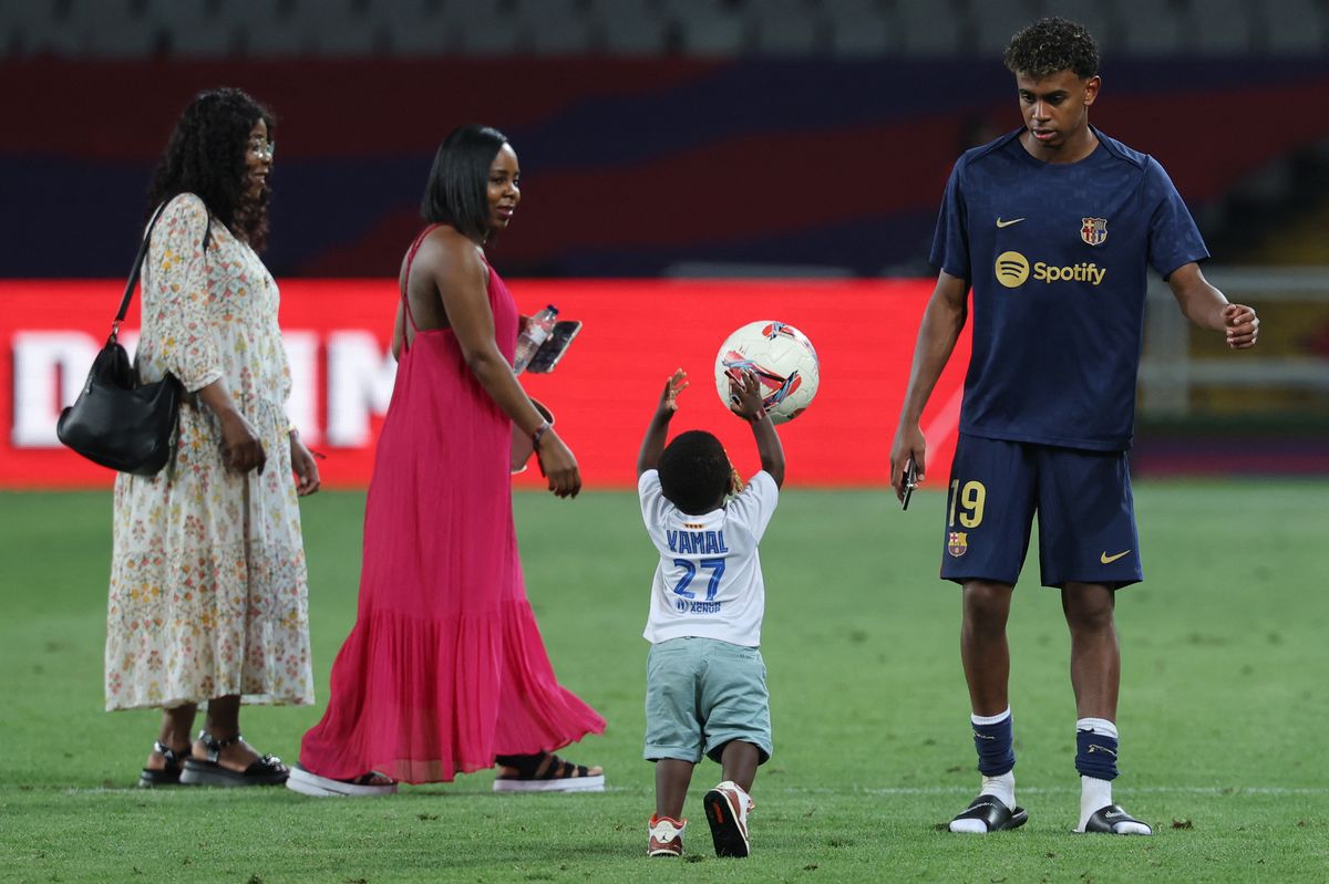 Lamine Yamal plays with his brother Keyne next to his mother Sheila Ebana (2L) and his grandmother, after the Spanish league football match between FC Barcelona and Athletic Club Bilbao