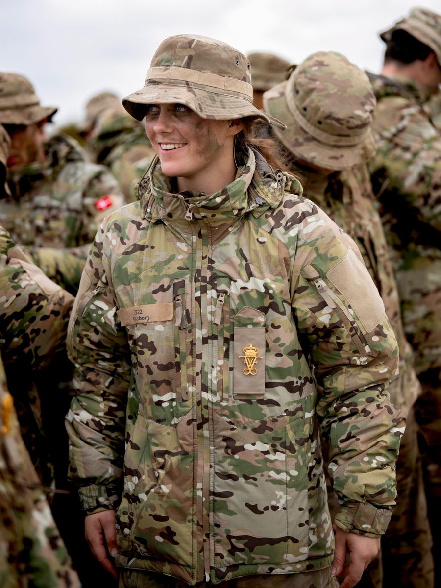 Princess Isabella smiles in camouflage after completing a demanding multiday military exercise alongside her fellow recruits.