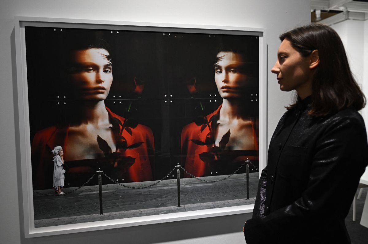 Russian photographer Anastasia Samoylova poses next to her photograph displayed at the Dot Fiftyone Gallery stand during the Paris Photo fair at the Grand Palais Ephemere in Paris, on November 10, 2023