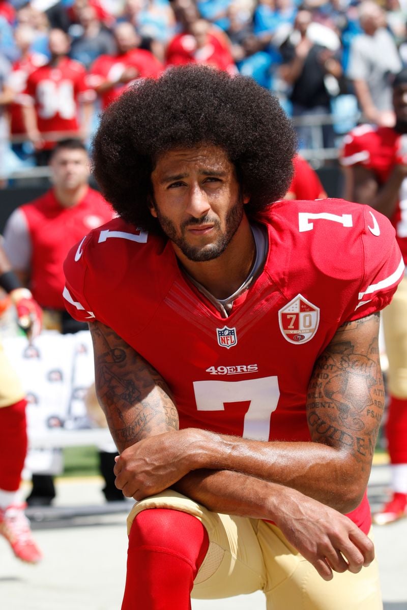 Colin Kaepernick #7 of the San Francisco 49ers kneels during the anthem prior to the game against the Carolina Panthers on September 18, 2016 in Charlotte, North Carolina