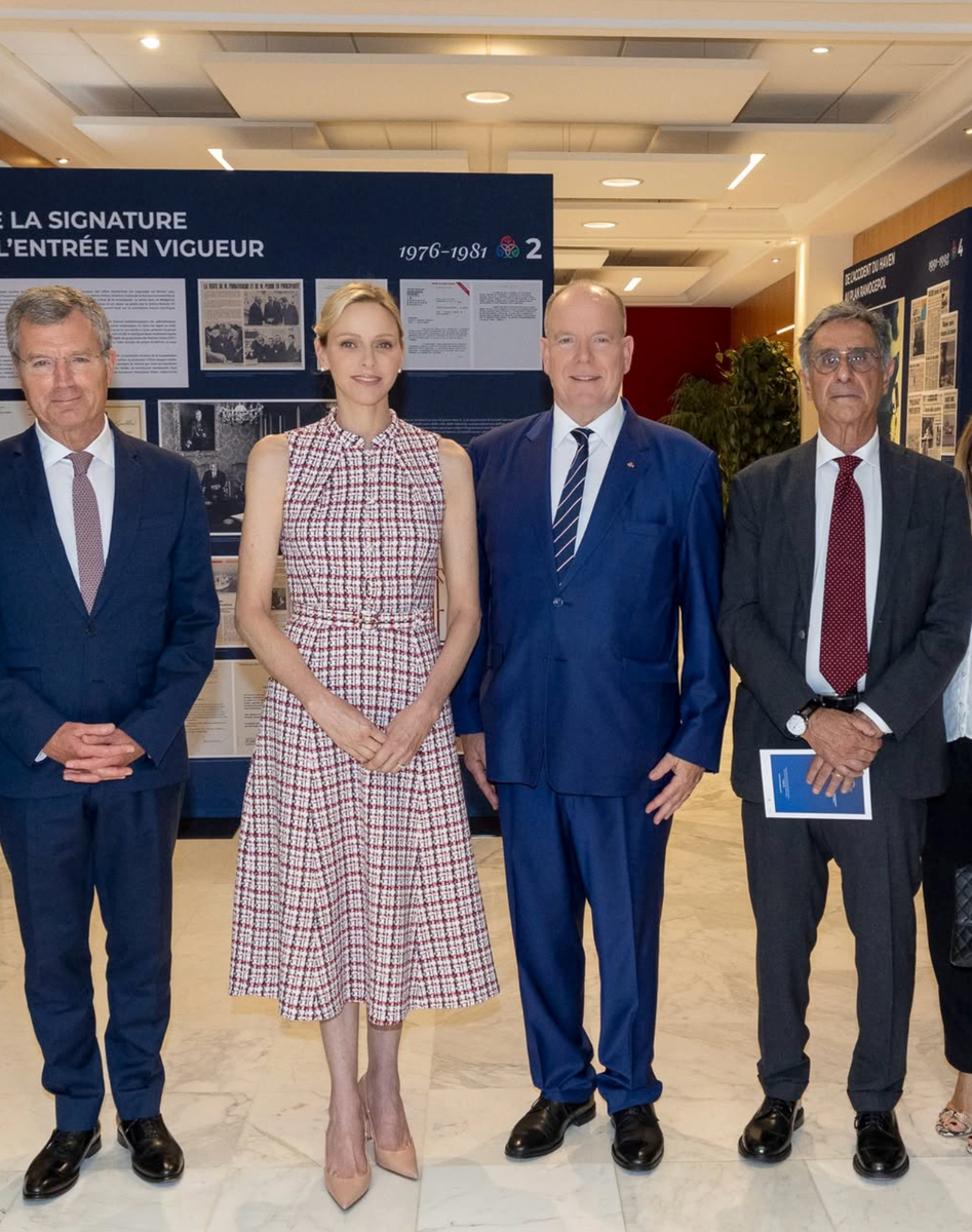 Princess Charlene and Prince Albert listened attentively as officials guided the royal couple through the commemorative RAMOGE exhibition at Monaco's Ministry of State.