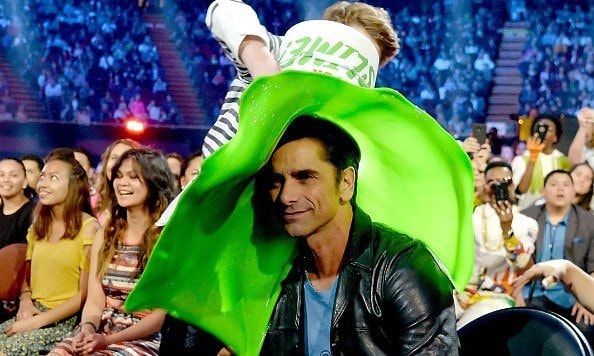 John Stamos got slimed thanks to a bucket-wielding Jace Norman.
<br>
Photo: Getty Images