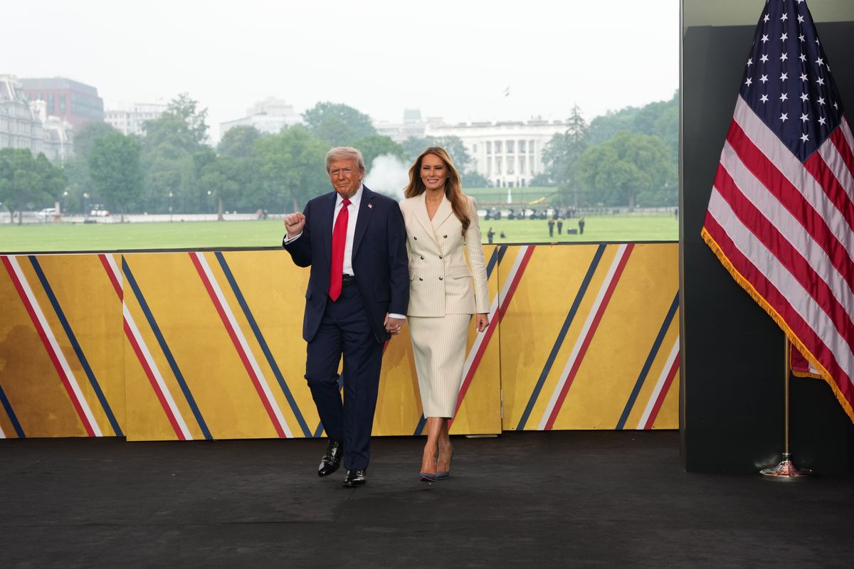 WASHINGTON, DC - JUNE 14: U.S. President Donald Trump and First Lady Melania Trump walk on stage during a celebration of the Army's 250th birthday on the National Mall on June 14, 2025 in Washington, DC. The U.S. Army is marking its 250th anniversary with a military parade along Constitution Avenue that includes roughly 6,600 troops, 150 vehicles, and over 50 aircraft.  The parade, which coincides with President Donald Trump's 79th birthday, is designed to tell the history of the Army. (Photo by Doug Mills - Pool/Getty Images)