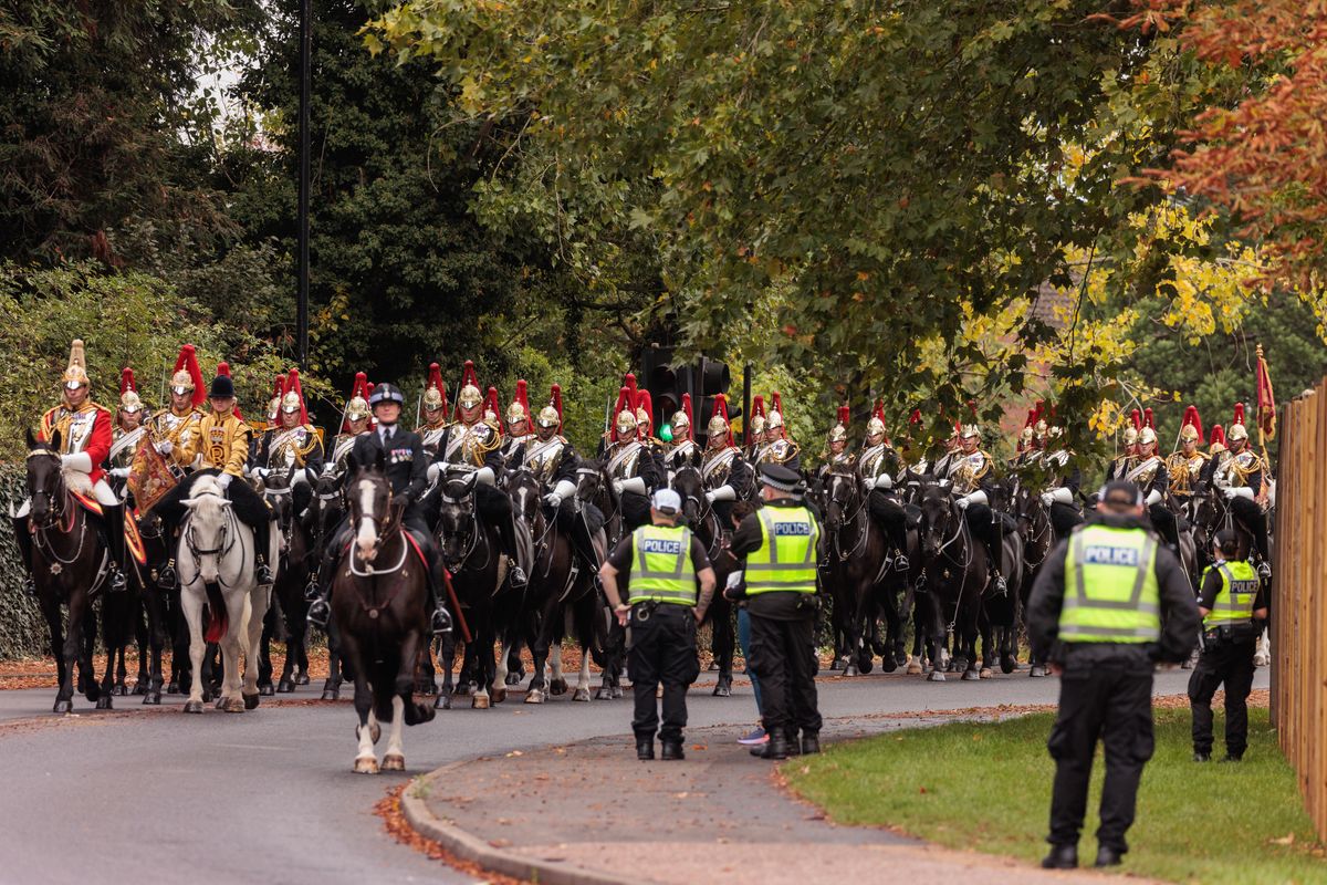 Mounted guards approach the Long Walk shortly before the arrival on Marine One of President Donald Trump and First Lady Melania Trump in Windsor