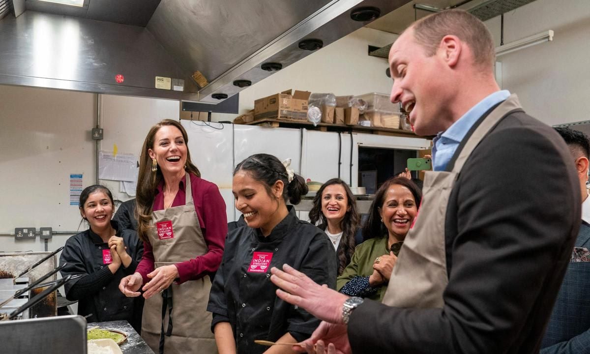 The Prince and Princess put on aprons and helped in the kitchen at the Indian Streatery, which is run by the Sharma family.