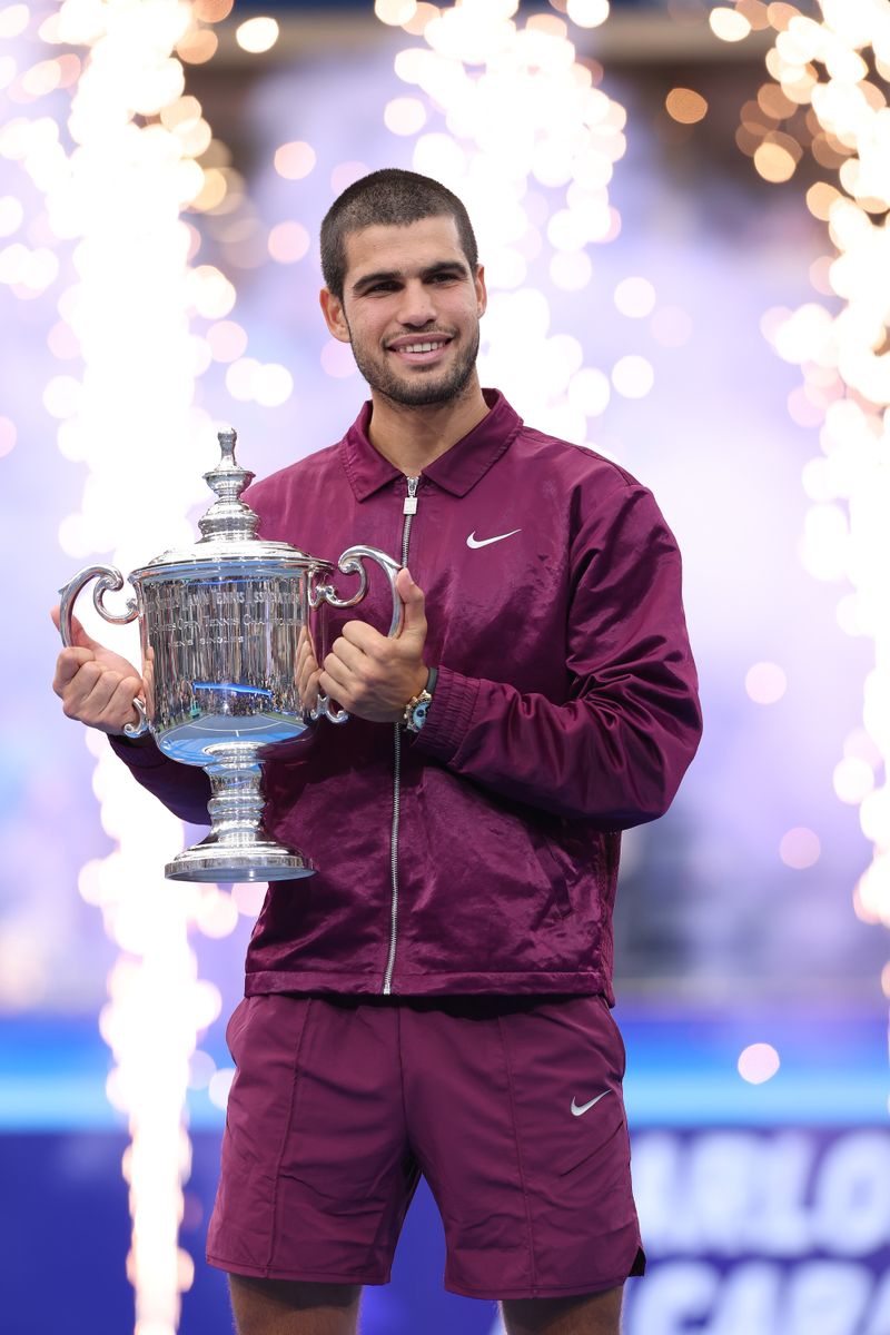 Carlos Alcaraz of Spain poses with his trophy after defeating Jannik Sinner of Italy during their Men's Singles Final match on Day Fifteen of the 2025 US Open 