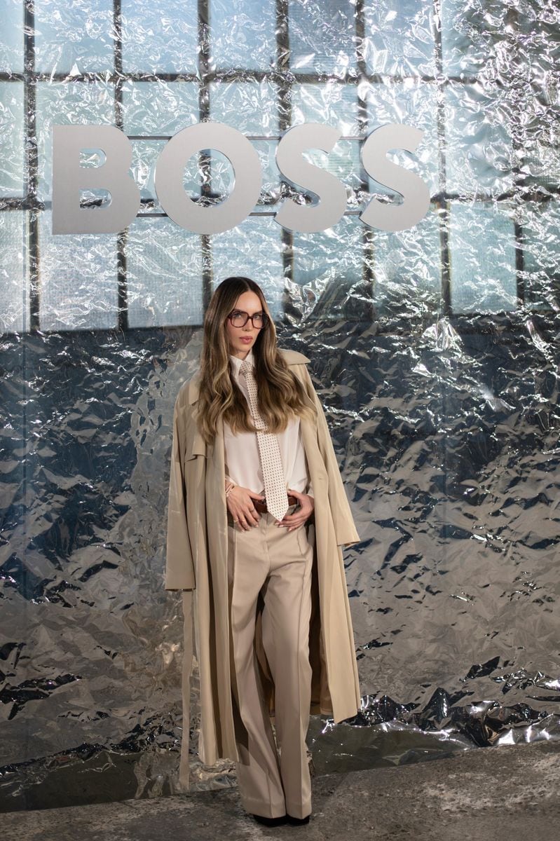 Belinda wore beige trousers and a trench coat over a white shirt and matching tie
